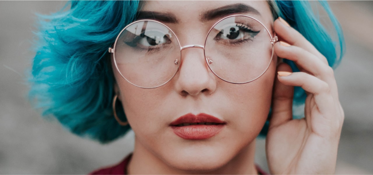 Woman with glasses staring straight ahead